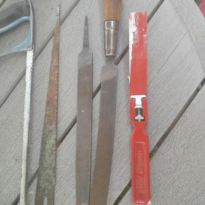 Hack saw with an assortment of files - one is nicely curved, and other small tools