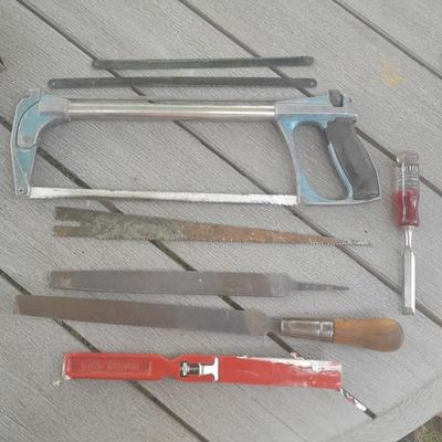 Hack saw with an assortment of files - one is nicely curved, and other small tools
