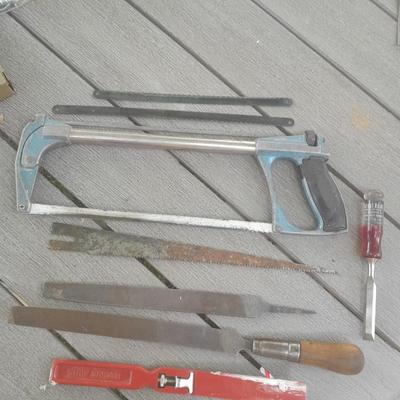Hack saw with an assortment of files - one is nicely curved, and other small tools