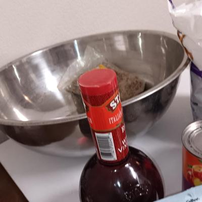 Large stainless-steel bowl full of groceries