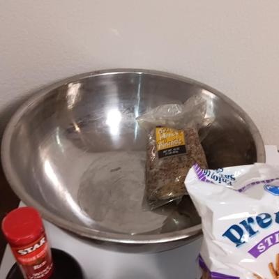 Large stainless-steel bowl full of groceries