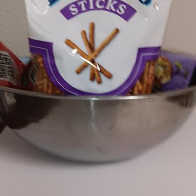 Large stainless-steel bowl full of groceries