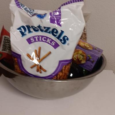 Large stainless-steel bowl full of groceries