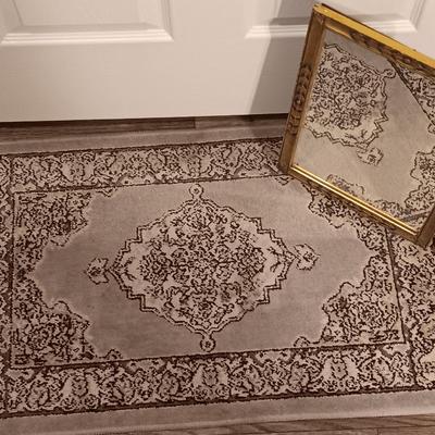 Antique gold framed mirror with a beautiful rubber backed throw rug