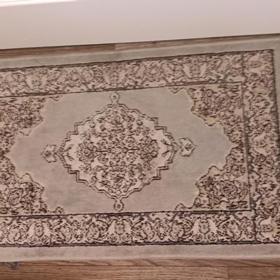 Antique gold framed mirror with a beautiful rubber backed throw rug