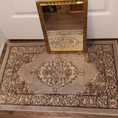 Antique gold framed mirror with a beautiful rubber backed throw rug
