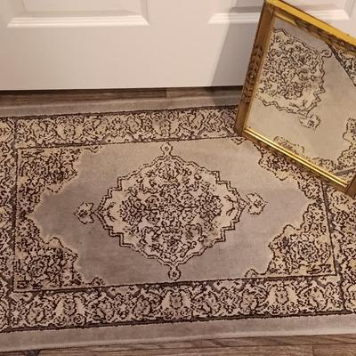 Antique gold framed mirror with a beautiful rubber backed throw rug