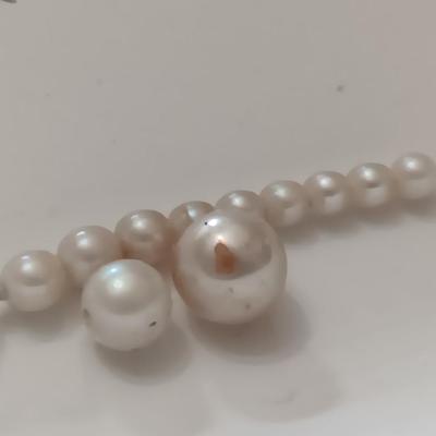 two larger freshwater pearls some smaller on a string