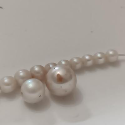 two larger freshwater pearls some smaller on a string