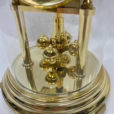 Howard Miller Clock Gold Tone Rotating Pendulum Glass Dome