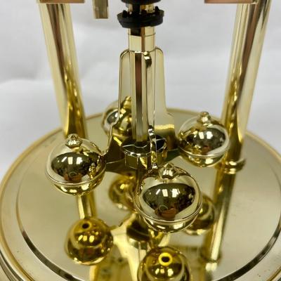 Howard Miller Clock Gold Tone Rotating Pendulum Glass Dome