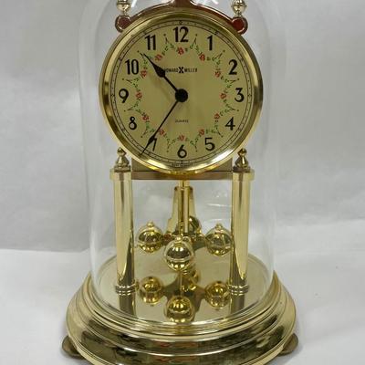 Howard Miller Clock Gold Tone Rotating Pendulum Glass Dome