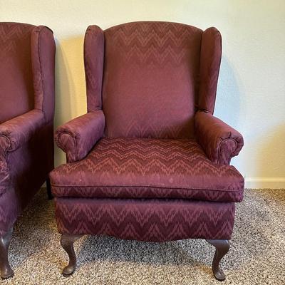 2 BURGUNDY WING BACK CHAIRS AND 1 OTTOMAN