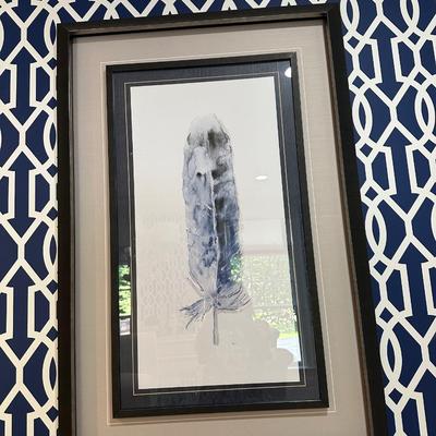 Two navy framed feather artwork