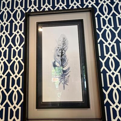 Two navy framed feather artwork