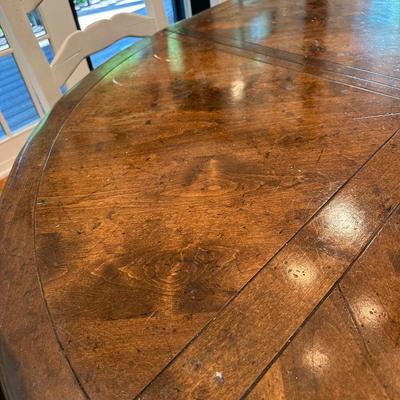 Oval wood dining table and six freshly upholstered chairs