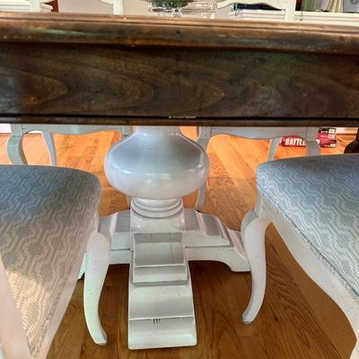 Oval wood dining table and six freshly upholstered chairs