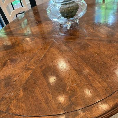 Oval wood dining table and six freshly upholstered chairs