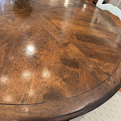 Oval wood dining table and six freshly upholstered chairs