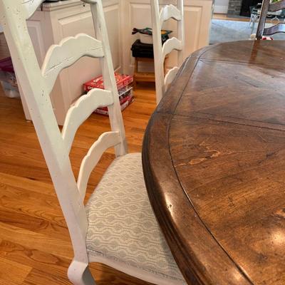 Oval wood dining table and six freshly upholstered chairs