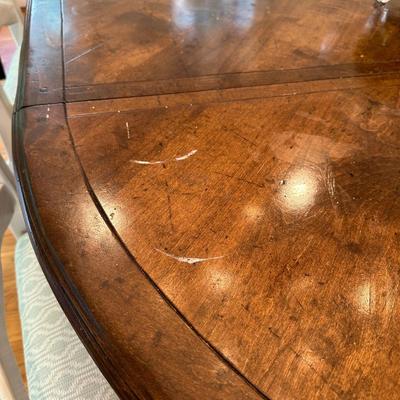 Oval wood dining table and six freshly upholstered chairs