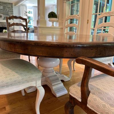 Oval wood dining table and six freshly upholstered chairs