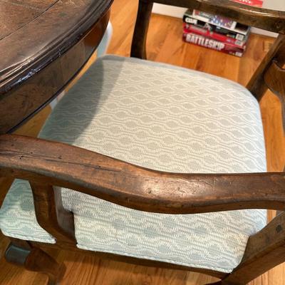 Oval wood dining table and six freshly upholstered chairs