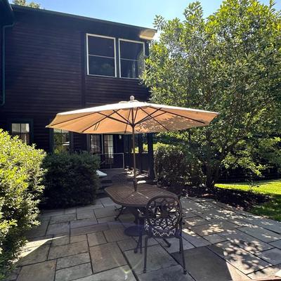 Outdoor metal table with two chairs and Pottery Barn umbrella