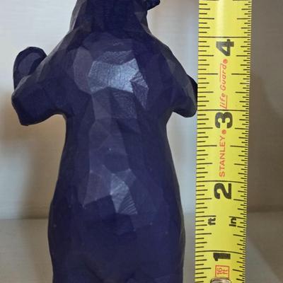 Blue Bear that Looks like he is Holding Up Books, Objects, Ect.