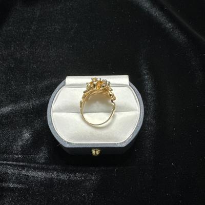 A ladies ring,cocktail style in 14kt gold. Set in the head are 7 full diamonds w/ the total weight of .75 carat.