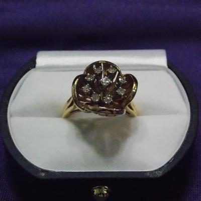 A ladies cocktail style ring in 14kt gold. It has 9 single cut diamonds w/ the total weight of .30 carats.