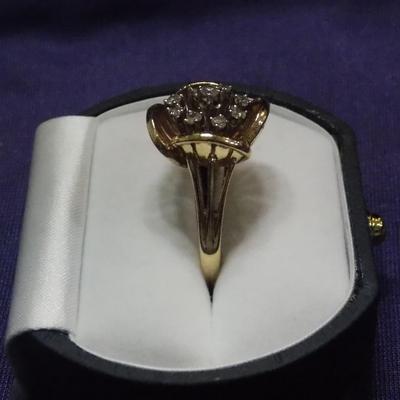 A ladies cocktail style ring in 14kt gold. It has 9 single cut diamonds w/ the total weight of .30 carats.