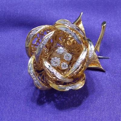 A brooch/pin in 18kt gold weighting approx of 37 grams. Total weight of Diamonds is .83 carats.