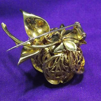 A brooch/pin in 18kt gold weighting approx of 37 grams. Total weight of Diamonds is .83 carats.