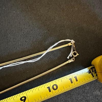 Three gold tone necklaces