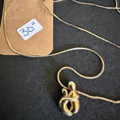 Three gold tone necklaces