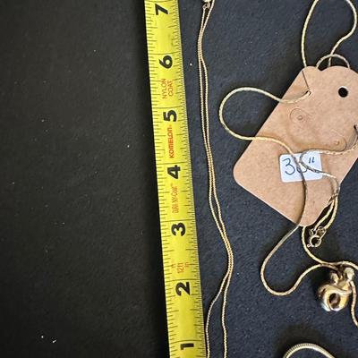Three gold tone necklaces