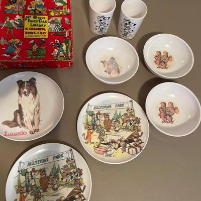 Box of books and plastic kids dinnerWare