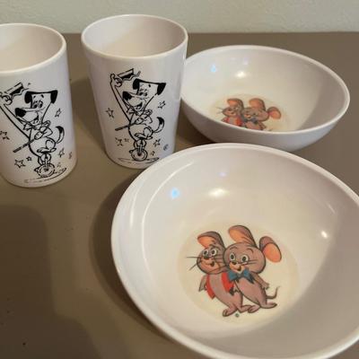 Box of books and plastic kids dinnerWare