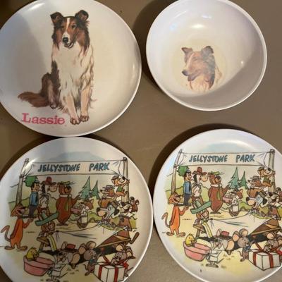 Box of books and plastic kids dinnerWare