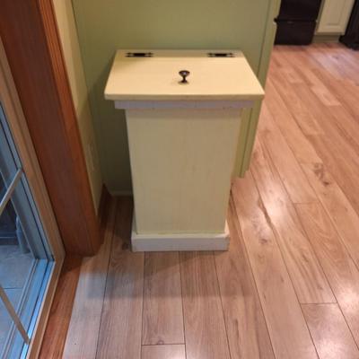 Yellow wooden trash bin