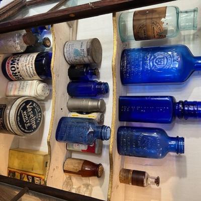 Vintage Display Cabinet with Old Medicine Bottles
