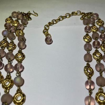 Vintage Preowned Gold-tone Triple Strand Pinkish Glass Bead Fashion Necklace 16-19" Adjustable in Very Good Preowned Condition.