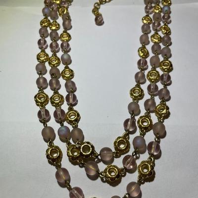 Vintage Preowned Gold-tone Triple Strand Pinkish Glass Bead Fashion Necklace 16-19" Adjustable in Very Good Preowned Condition.