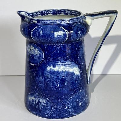 ROWLAND MARSELLUS HISTORICAL POTTERY PITCHER IN BLUE & WHITE WITH VIGNETTES OF VARIOUS HISTORICAL SCENES INCL WILLIAM PENNS TREATY,...