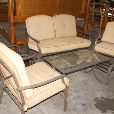 Patio furniture set with armchairs, table with glass top and settee