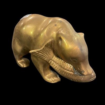 Brass bear eating a fish