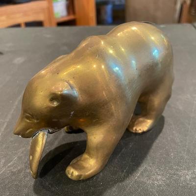 Brass bear eating a fish