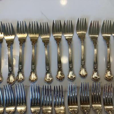 Silver- Essentials in Silver, 10 dinner knives, 12 forks, 10 spoons, 10 salad forks, 11 soup spoons
