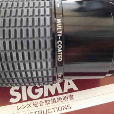 Two 35 mm camera lenses - Sigma - Vivitar 2X Tele Converter both with instructions 35mm camera